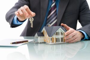 Man holding keys with house